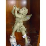 Small statute of Winged Child playing wind instrument.