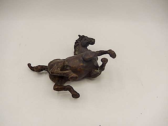 A bronze of a horse rolling 5" long