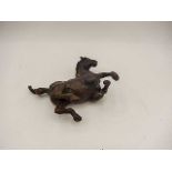 A bronze of a horse rolling 5" long