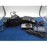 Canon EOS 3000, Canon prima zoom 70f in case, and Canon digital iXUS 70 with battery charger