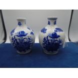 Pair of blue and white flowered bulbous vases, 7" high