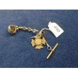 A silver 3 sided revolving fob and silver chain with a gold miniature pipe and a floral cross