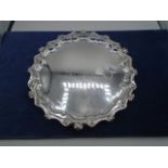 Silver salver with bow and scroll edge on bun feet, 11" wide, Sheffield 1937, 565g