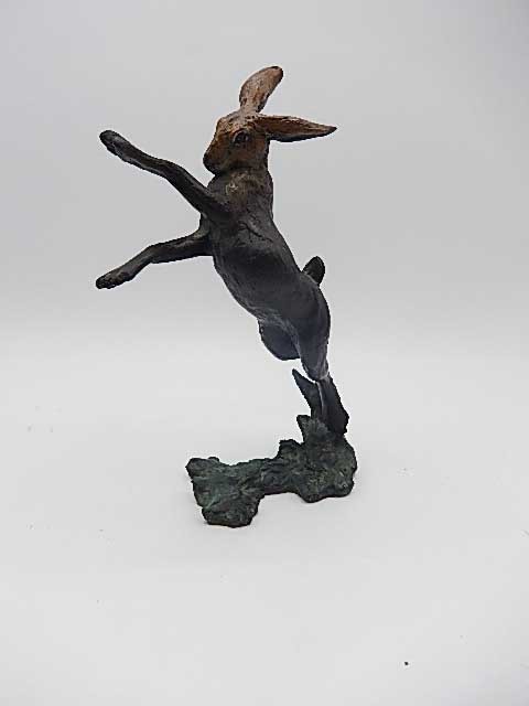 A CONTEMPORARY BRONZE OF A LEAPING HARE, signed 16/75, 7" tall