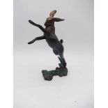 A CONTEMPORARY BRONZE OF A LEAPING HARE, signed 16/75, 7" tall