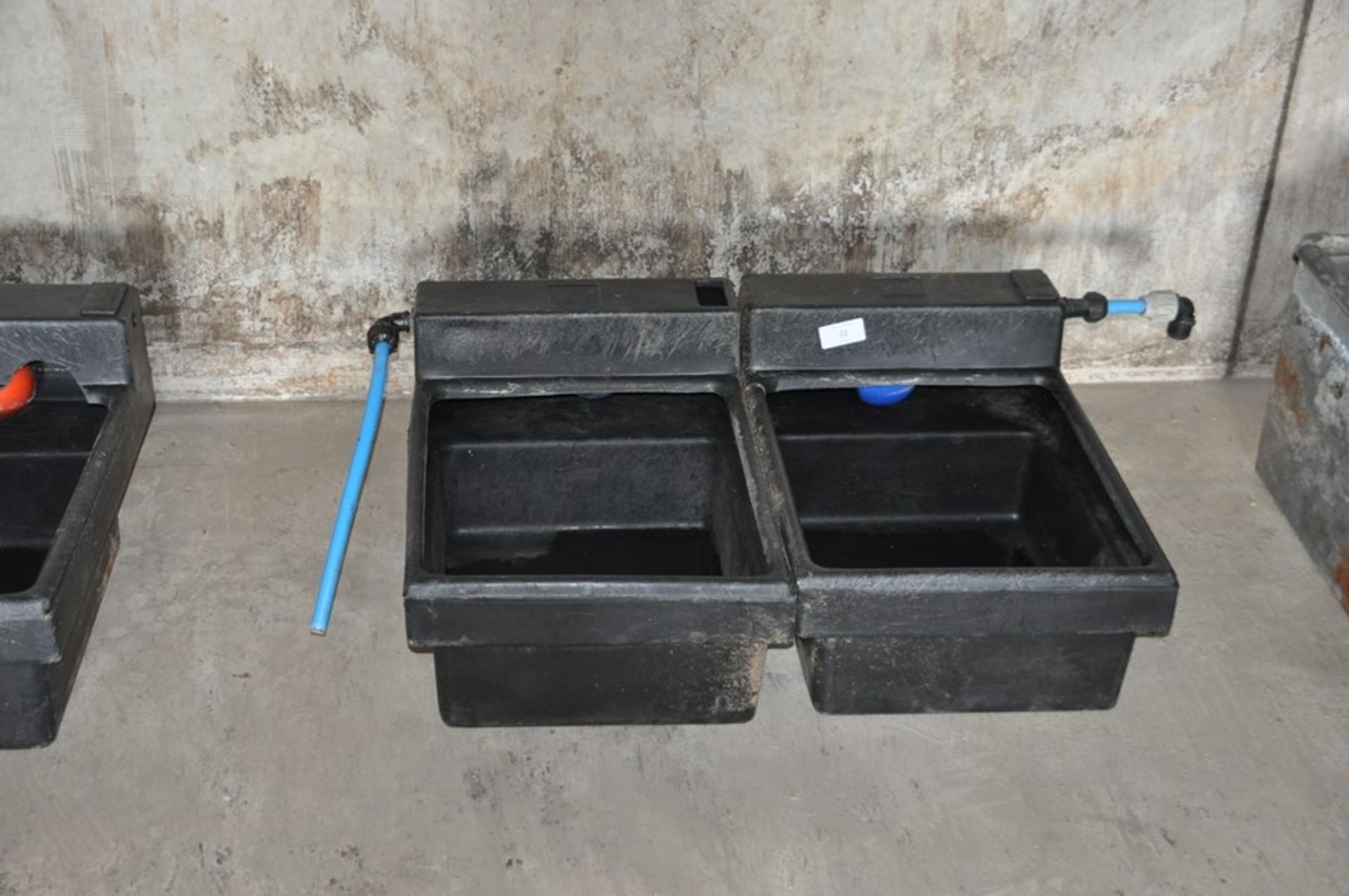 2 plastic livestock water troughs