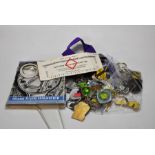 A collection of souvenir badges mostly of Norwich City FC; souvenir platform ticket and magnifier