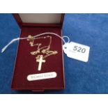 A boxed 9ct cross pendant and chain, .52gm