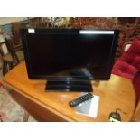 Toshiba 26 inch TV with remote and book from house clearance