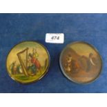 2 antique circular papier mache snuff boxes, one featuring a rural scene with the caption 'Le bon
