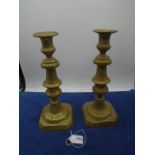 Pair of antique brass candlesticks with ejectors, approx 26cm tall