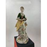 A sitzendorf porcelain figurine of a shepherdess with lamb