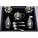 Cased eight piece sterling silver cruet set