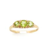 Three stone peridot and 9ct yellow gold ring