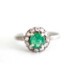 Emerald and silver halo ring