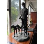 Large bronzed figure of a man and two dogs