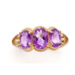 Three stone amethyst and 9ct yellow gold ring