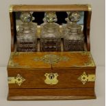 Edwardian English oak three decanter tantalus