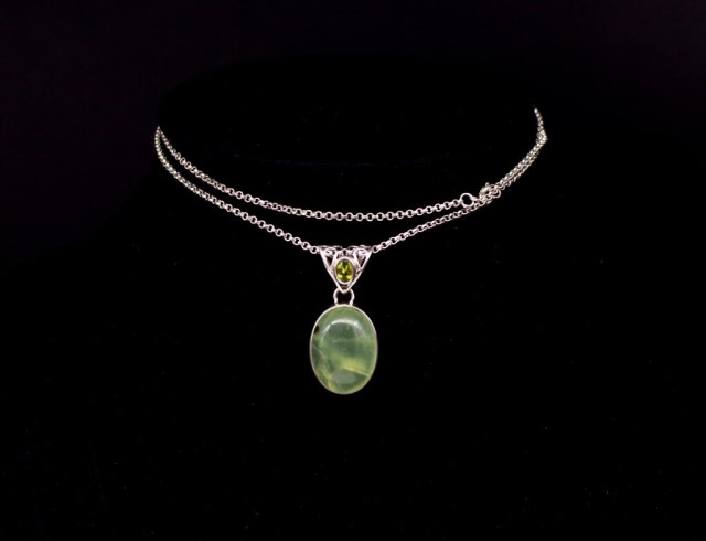 Green gemstone and silver pendant and chain