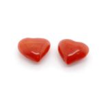 Two loose matched carved red coral hearts