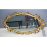 Ornate gilt flamed mirror