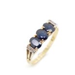 Three stone sapphire and 9ct yellow gold ring