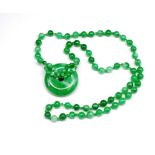 Green jade bead necklace and bi disc pendant