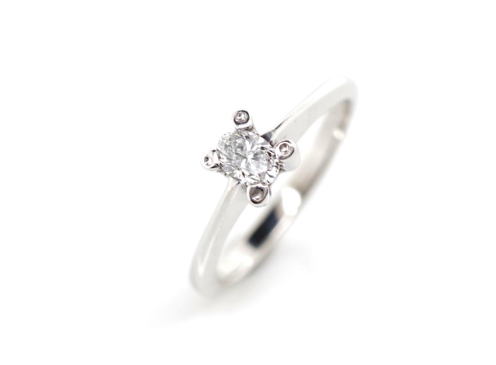 Oval cut diamond and 18ct white gold ring