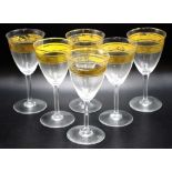 Six Baccarat gilt decorated stemmed wine glasses