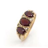 Three stone garnet set 9ct yellow gold ring