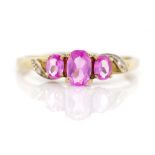 Three stone pink topaz and 9ct yellow gold ring