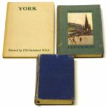 Three antique tourist guide books