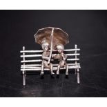 Silver miniature of children on park bench figure