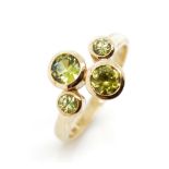 Four stone peridot and 9ct yellow gold ring