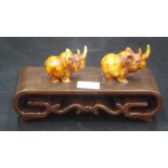 Chinese carved Rhino figures on wood stand