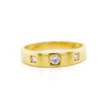 Three stone diamond and 18ct yellow gold ring