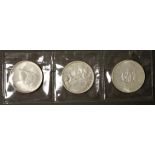 Three Canadian silver dollar coins