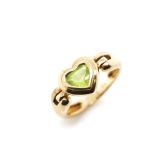 A large peridot heart and 9ct yellow gold ring