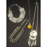 Four various silver metal tribal necklaces