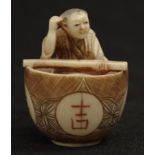 Japanese carved ivory Man in a Rice Bowl netsuke