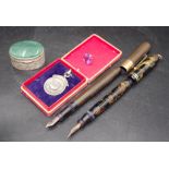 Two vintage fountain pens, hallmark medal, trinket
