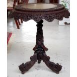 19th century ornately carved tripod table