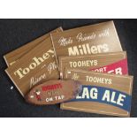 Six various Tooheys advertsing signs