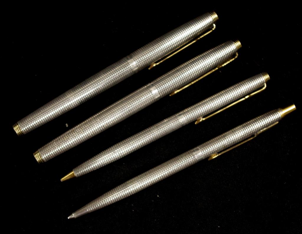 Four Parker silver pens