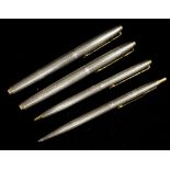 Four Parker silver pens