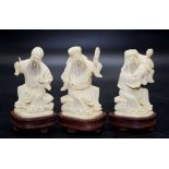 Three Chinese carved ivory figures on stands