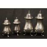 Two various pairs Edwardian silver pepperettes