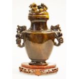 Chinese tigers eye lidded urn on a timber stand