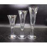 Three Kosta Boda glass graduated stemmed glasses