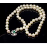 Pearl necklace with a diamond and emerald clasp